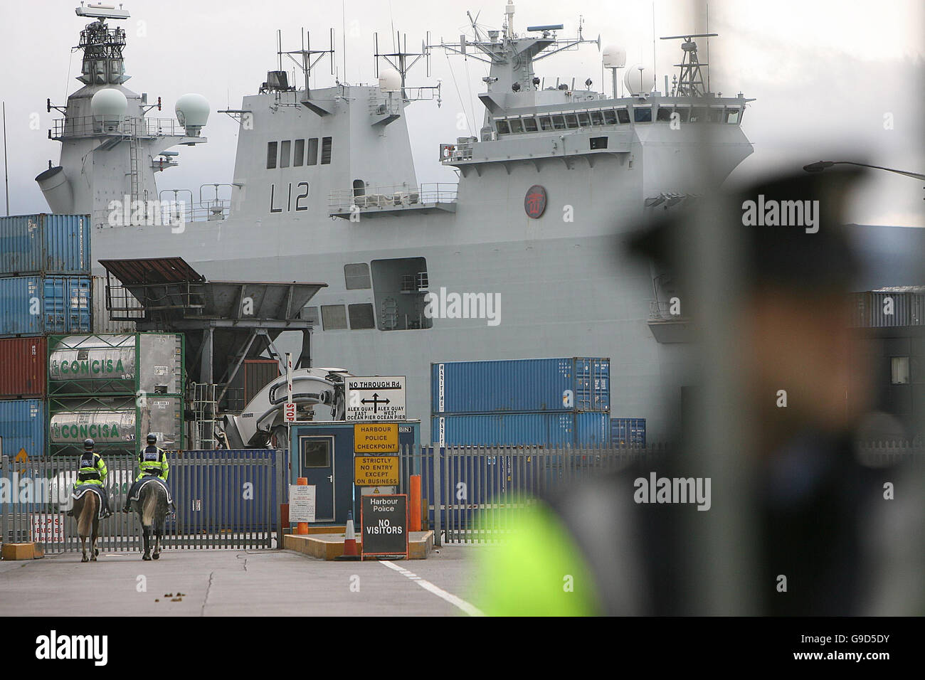 HMS Ocean under heavy Garda protection as anti-war activists marhced against the visit of British war ship to Dublin port. Stock Photo