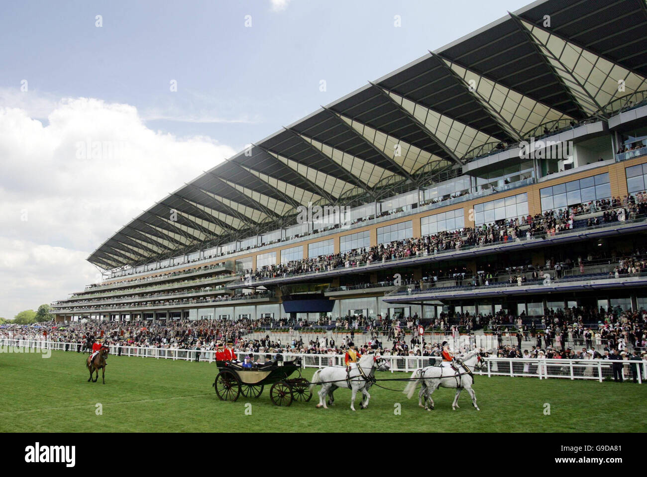 Queen Elizabeth II arrives in a horse-drawn carriage for the first day of racing at the new state-of-the-art course at Ascot in Berkshire. Stock Photo