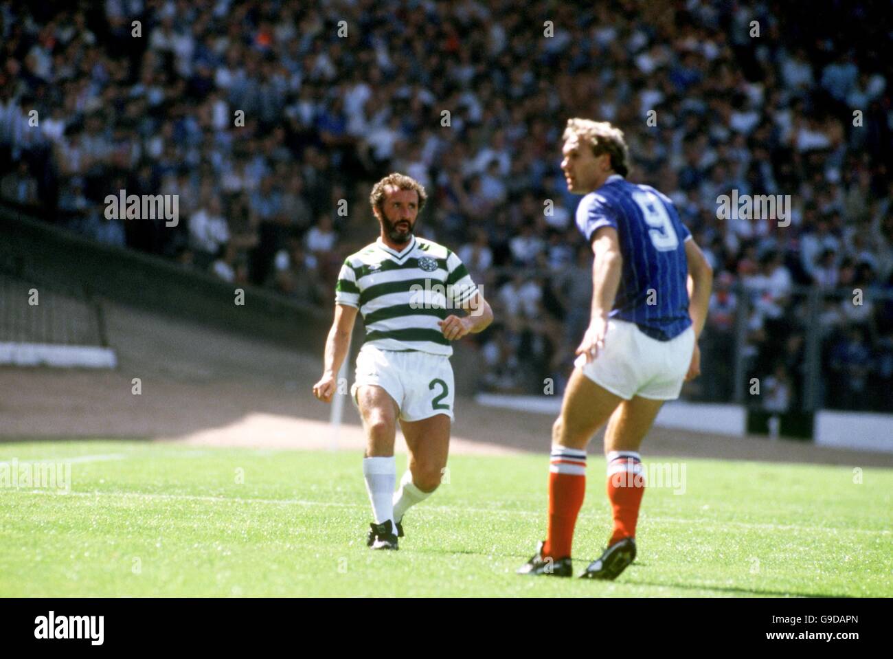 Scottish Soccer - Glasgow Cup - Final - Celtic v Rangers - Hampden Park. Danny McGrain of Celtic (l) plays the ball past Rangers' Sandy Clark (r) Stock Photo