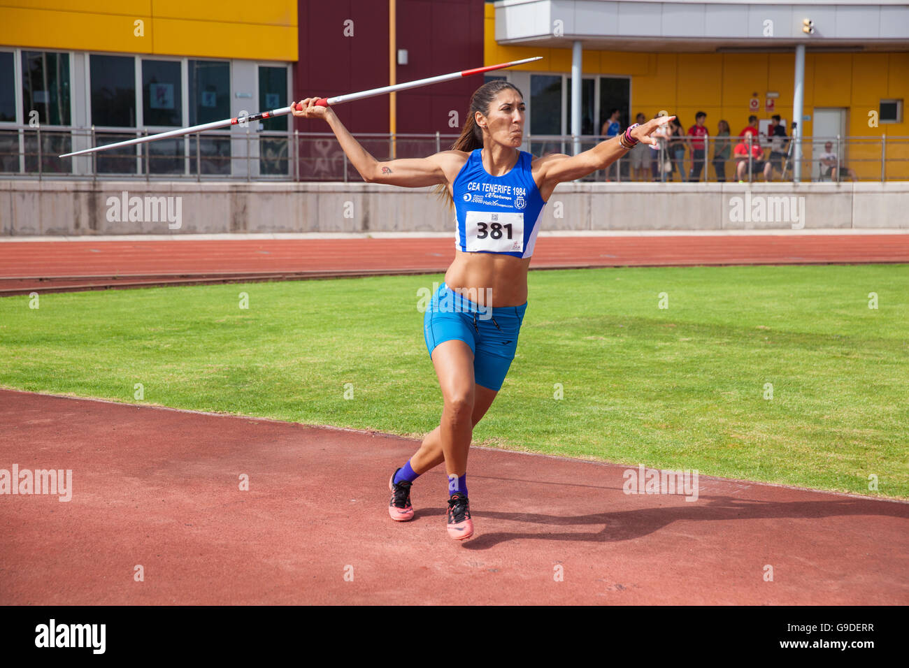 young woman throwing javelin on an athletic piste Stock Photo