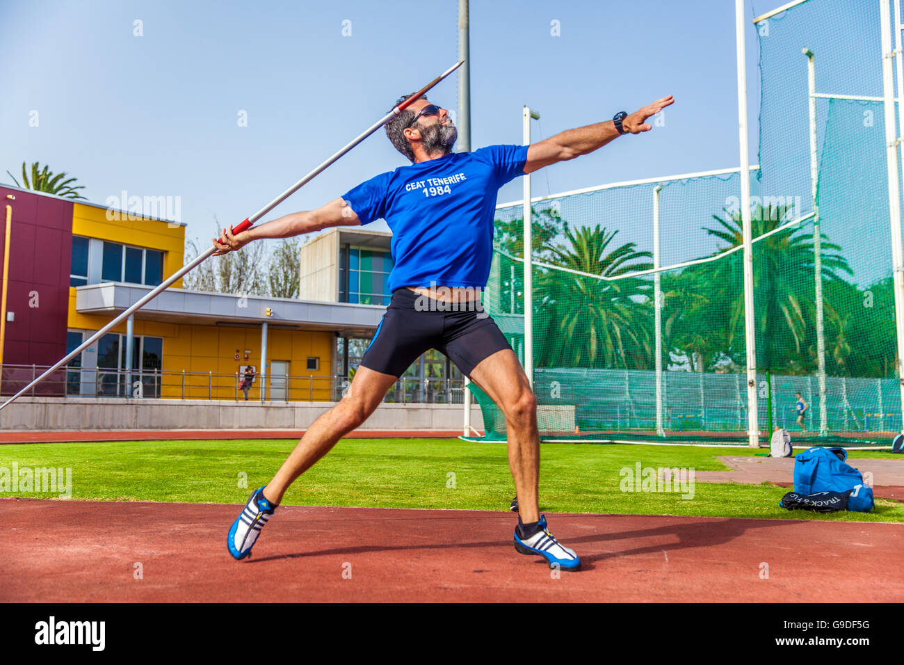 Young sportsman throwing javelin on an athletic piste Stock Photo Alamy