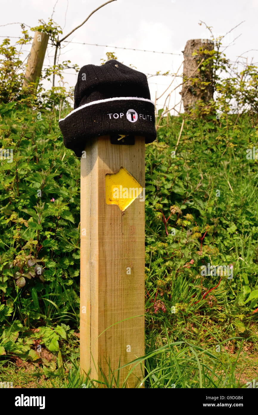 Lost and found - a woolly hat on a waymarker post. Stock Photo