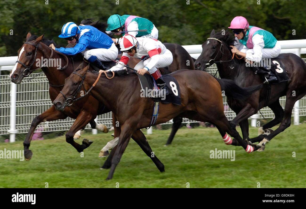 Red Evie, ridden by Frankie Dettori (number 8) wins the Oak Tree Stakes at Goodwood racecourse. Stock Photo