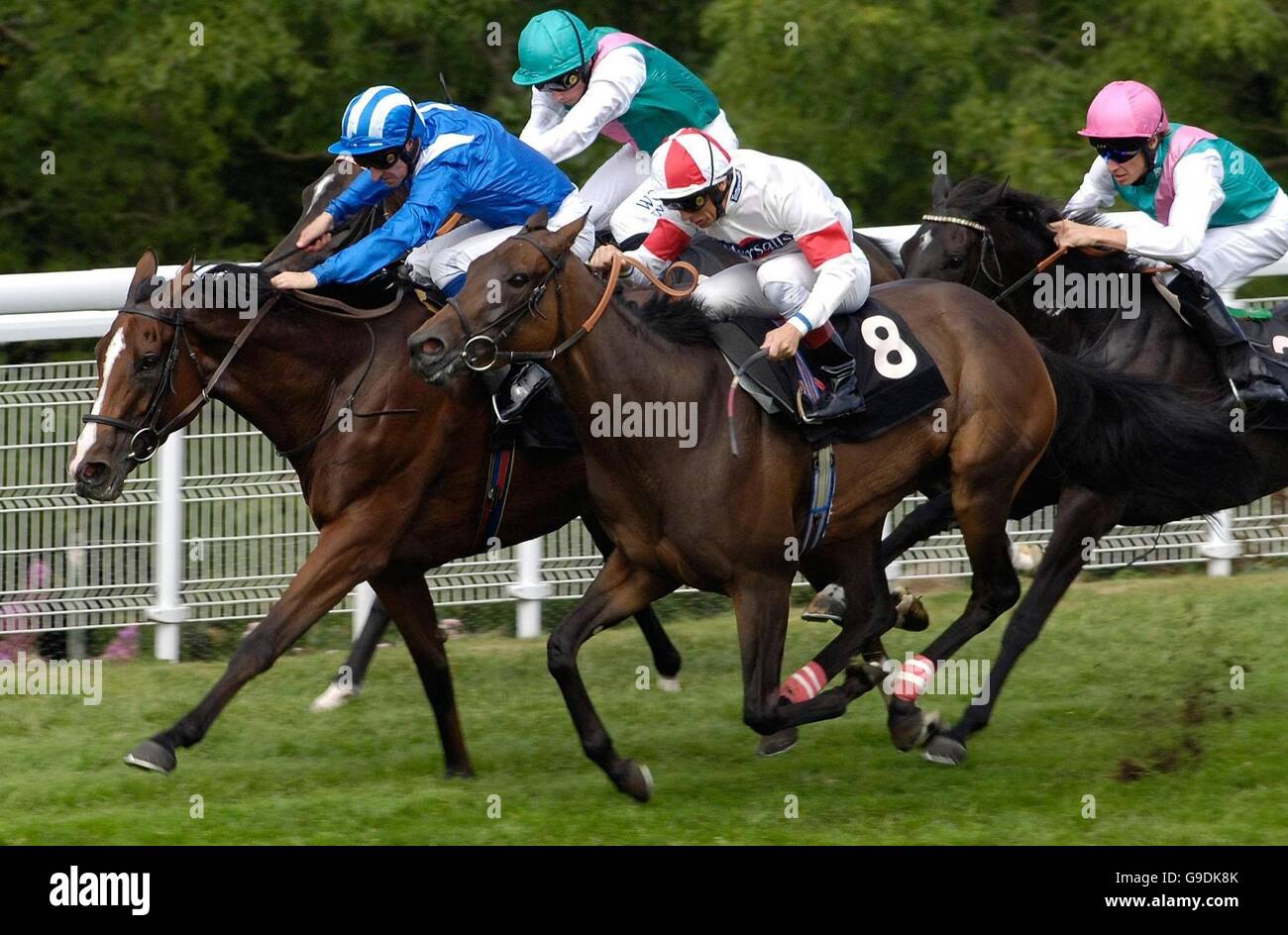 Red Evie, ridden by Frankie Dettori (number 8) wins the Oak Tree Stakes at Goodwood racecourse. Stock Photo