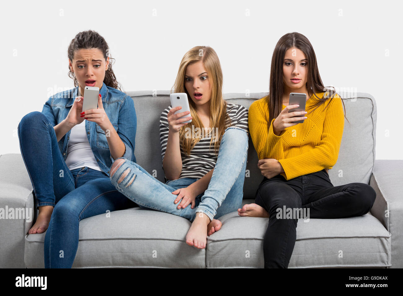 Happy teen girls at home using cellphone Stock Photo - Alamy