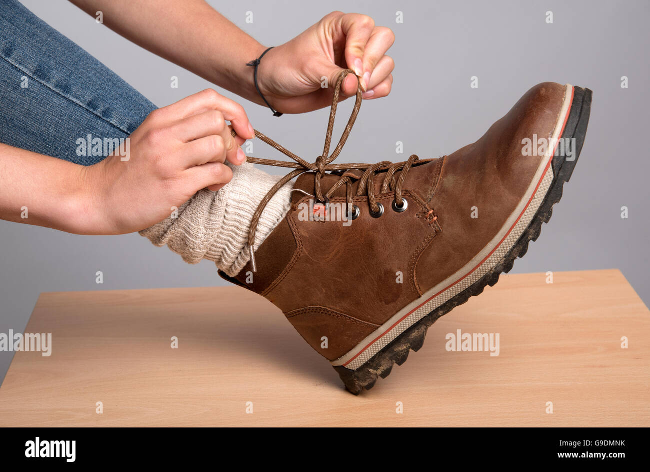 Woman tying the laces on her walking boot Stock Photo Alamy