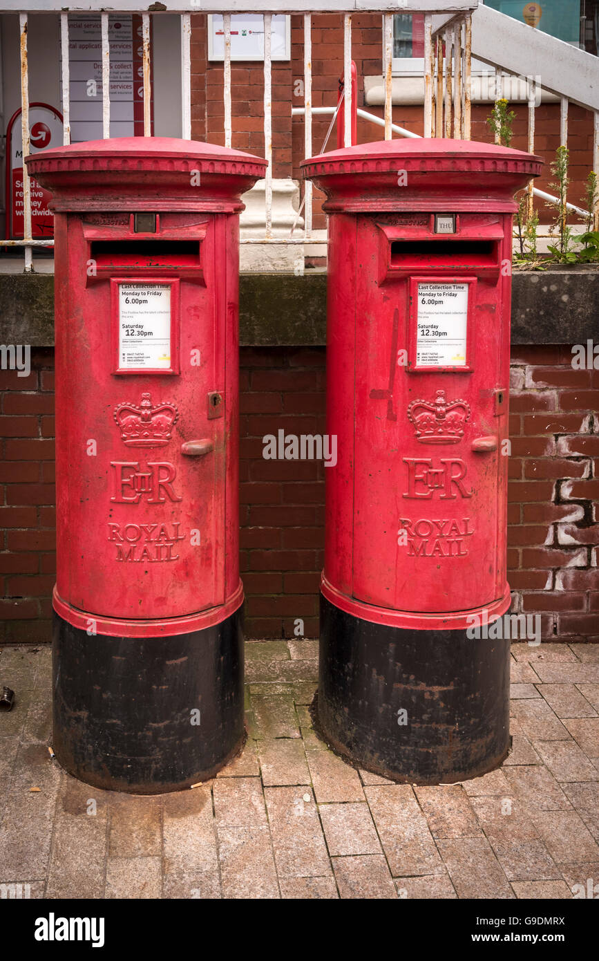 A pair of English red pillar boxes post boxes postboxes. postbox Stock