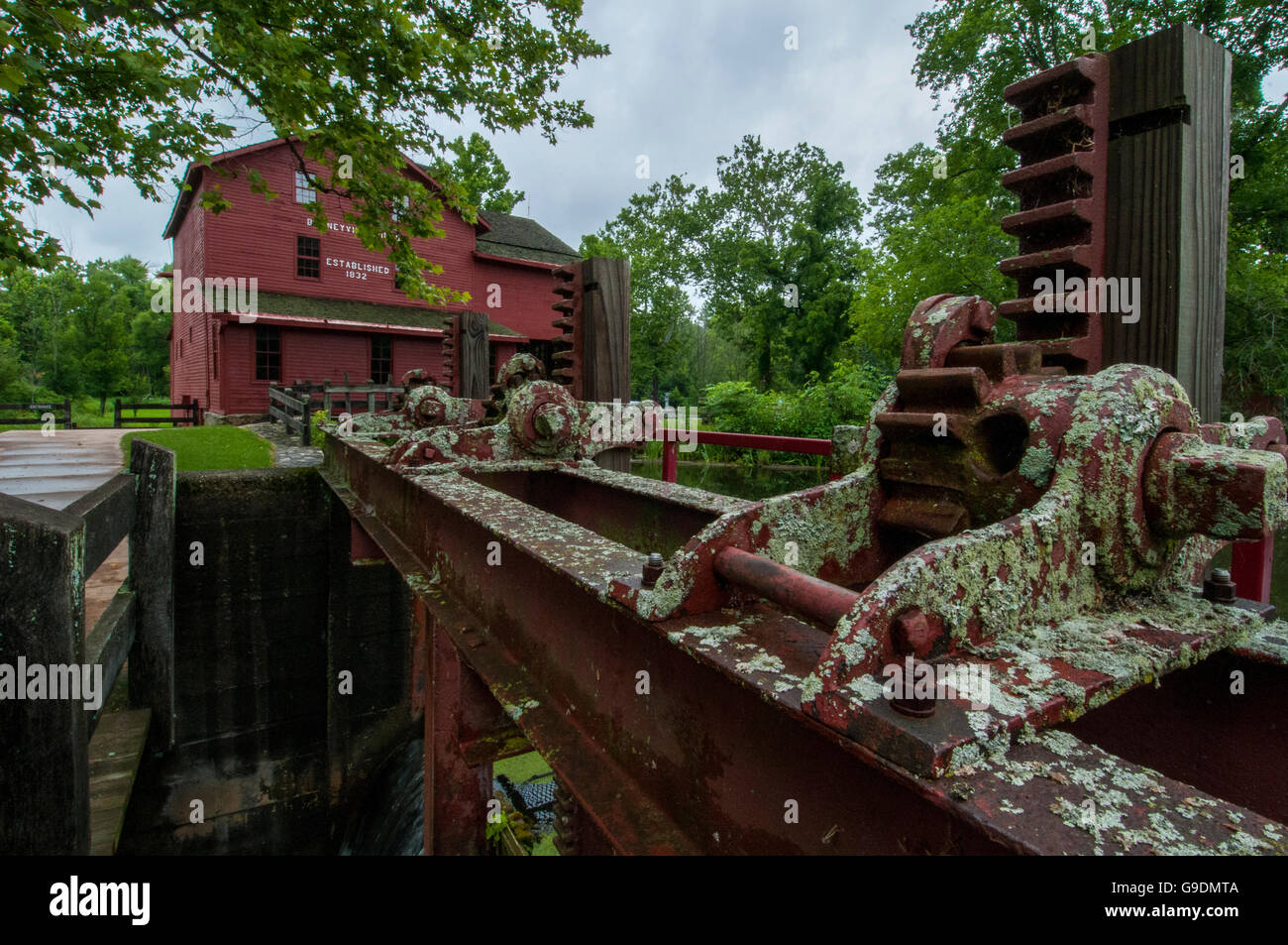 The gears and machinery to raise and lower water level at a grist mill. Stock Photo
