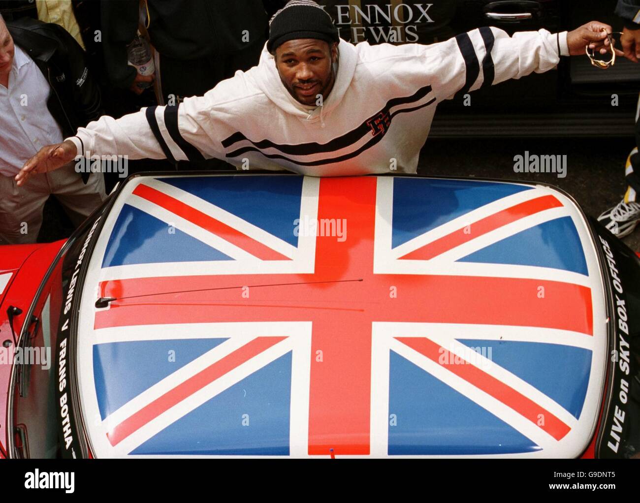 WBC Heavyweight champion Lennox Lewis stands by a mini with a Union flag roof, outside Cabot Hall, Canary Wharf Stock Photo