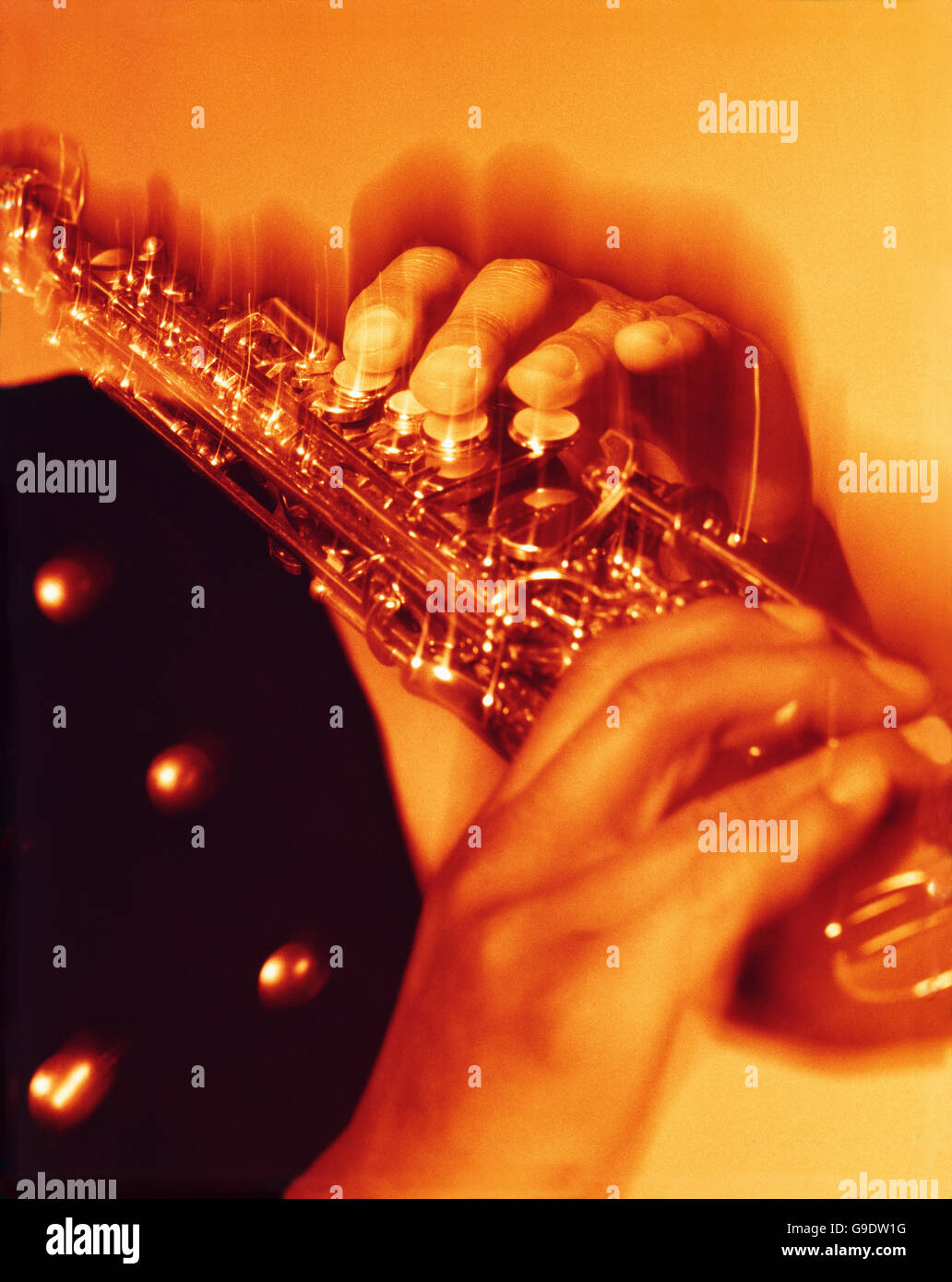 Musician playing tenor sax showing the movement of fingers pressing the keys Stock Photo