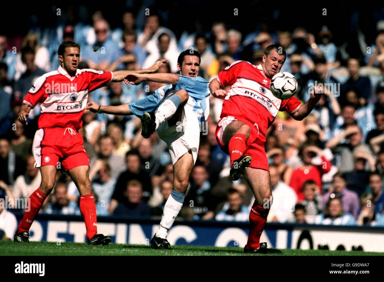 Middlesbrough's Steve Vickers (l) looks on as teammate Gary Pallister (r) challenges Coventry City's Cedric Roussel (c) Stock Photo