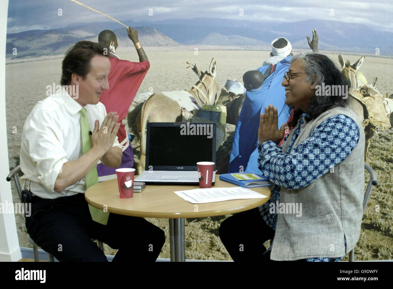 Conservative party leader David Cameron (left) meets campaign executive Pushpanath Krishna Murthy of the charity Oxfam and takes part in a weblink inside Oxfam House in Oxford. Stock Photo