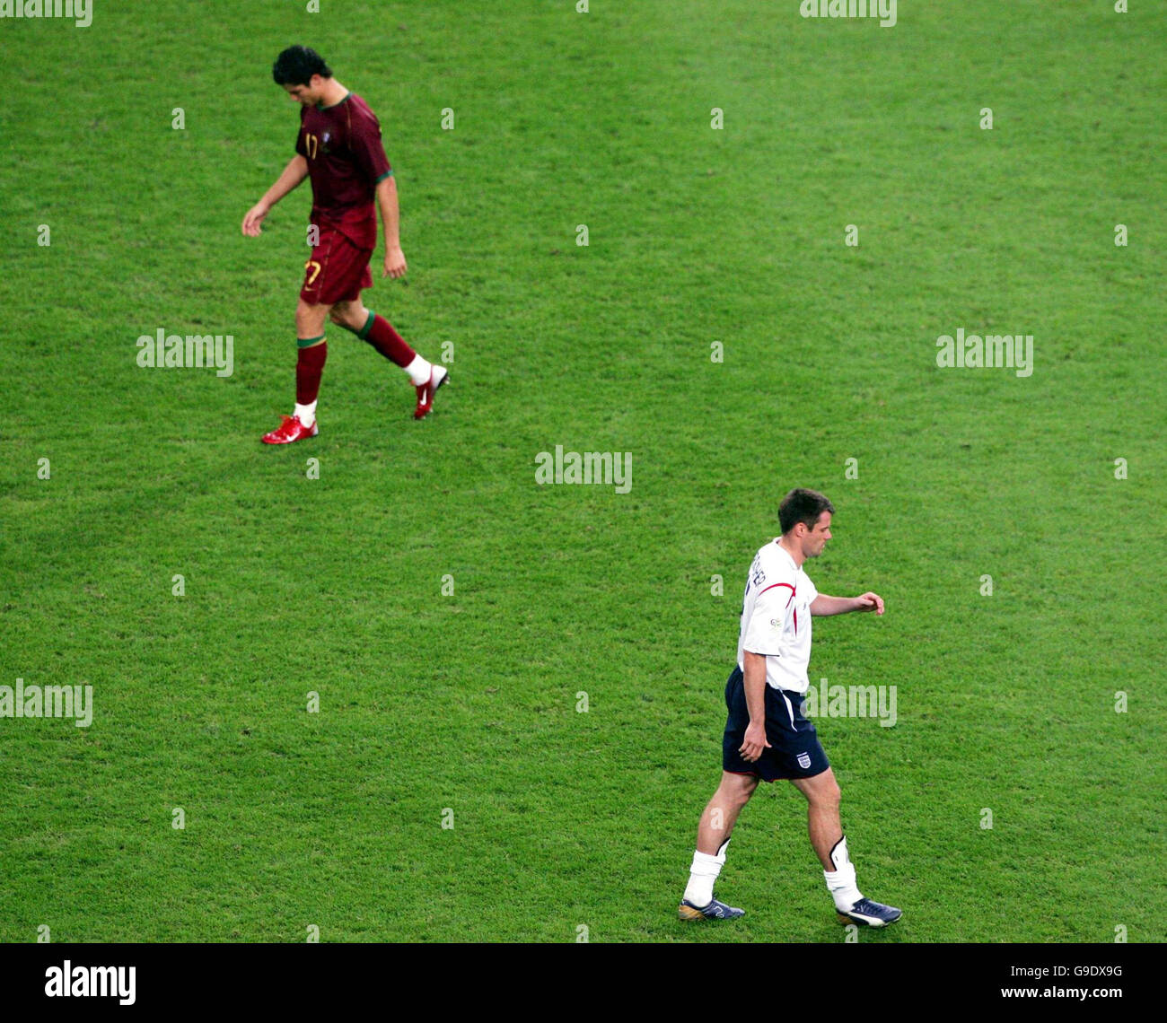 England's Jamie Carragher shows his dejection after his missed penalty as Portugal's Cristiano Ronaldo (top) walks forward to score the winning goal in penalty shoot-out during the Quarter Final match at the FIFA World Cup Stadium in Gelsenkirchen, Germany. Picture date: Saturday July 1, 2006. Stock Photo