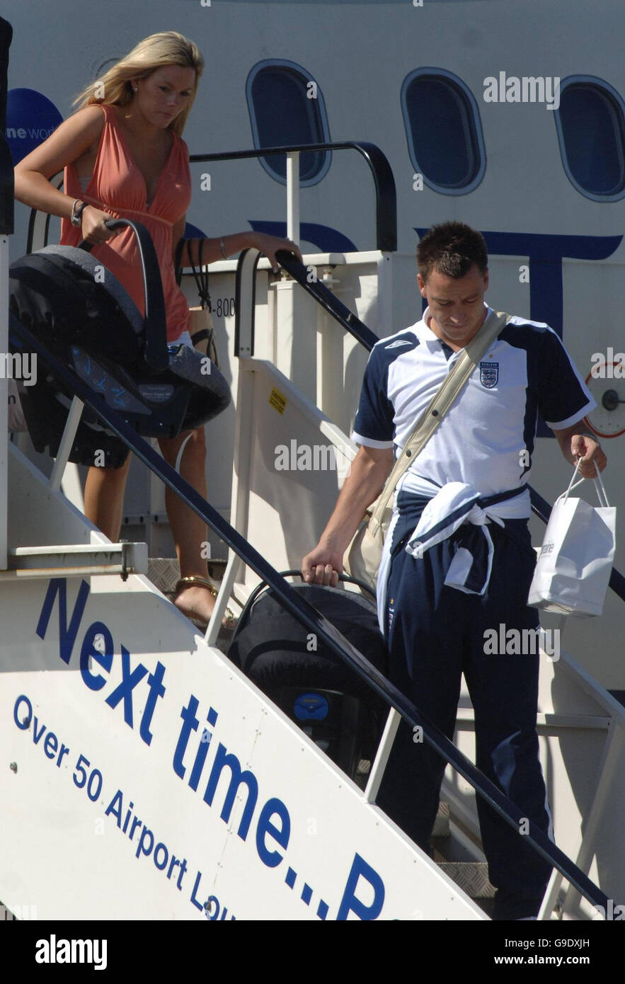 England player John Terry and his partner Toni Poole at Stansted Airport in Essex as the England football team to return from Germany after they were knocked out of the World Cup quarter finals by Portugal yesterday. Stock Photo