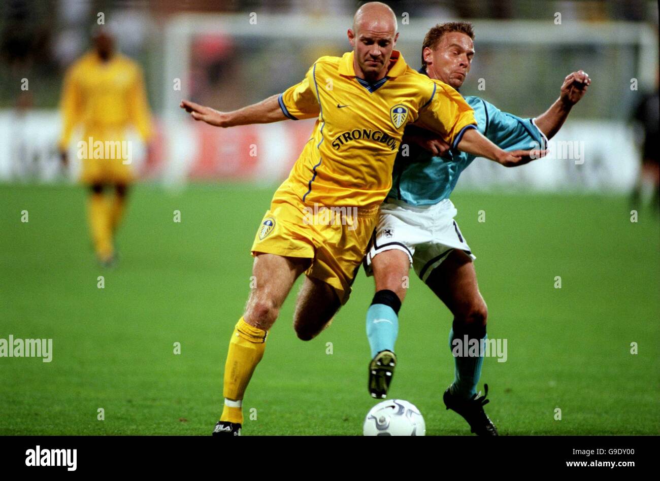 TSV Munich 1860's Thomas Hassler (r) is held off by Leeds United's Danny Mills (l) Stock Photo