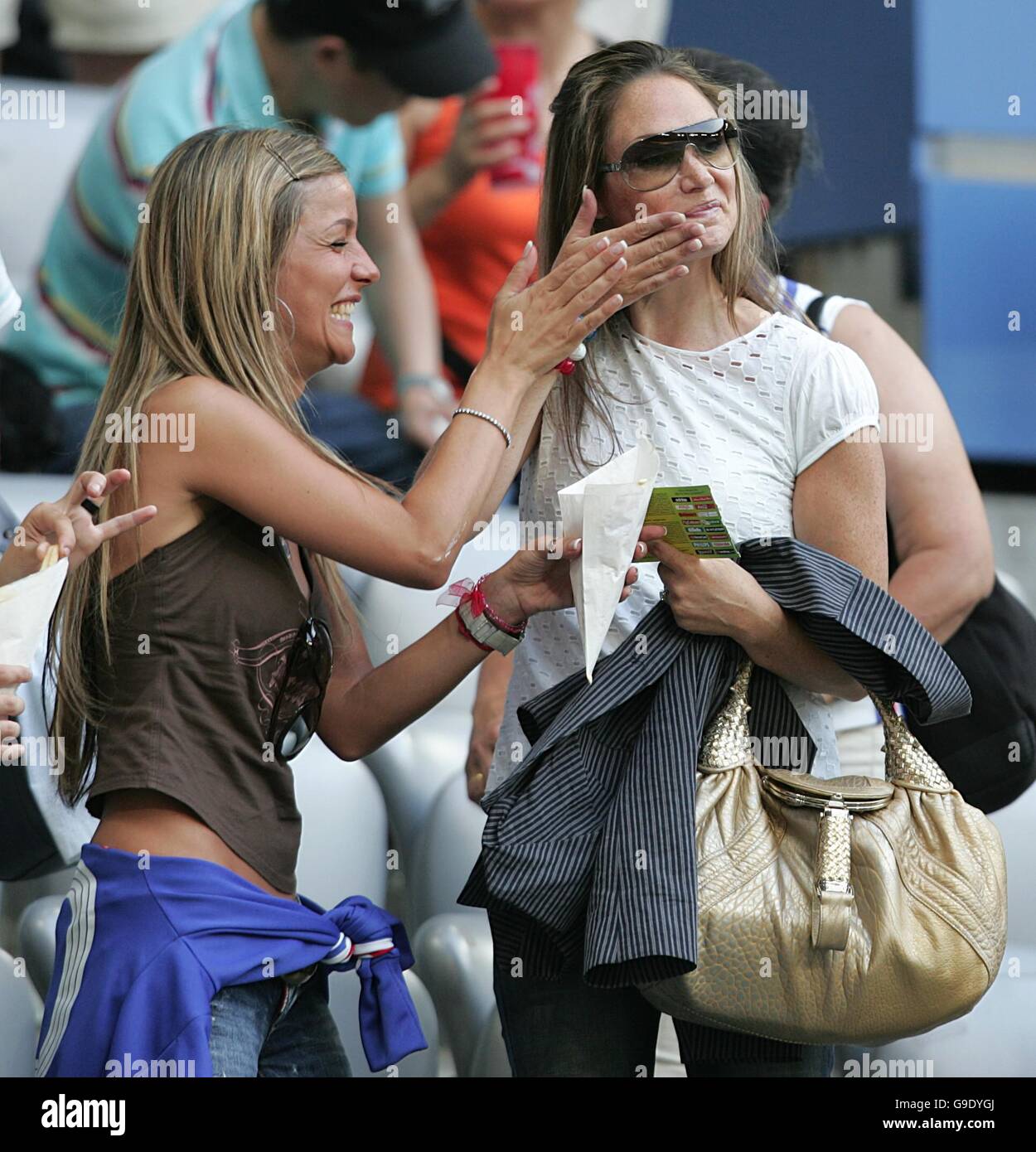 Soccer - 2006 FIFA World Cup Germany - Semi Final - Portugal v France - Allianz Arena. Beatrice wife of French footballer David Trezeguet (L) with Nicole Merry wife of Thierry Henry (R) Stock Photo
