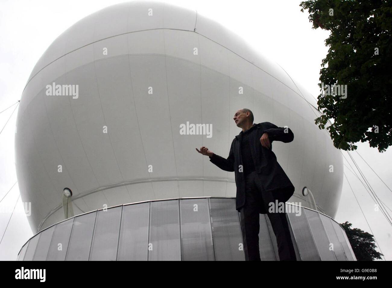 Architect Rem Koolhaas stands in front of the new inflatable canopy at