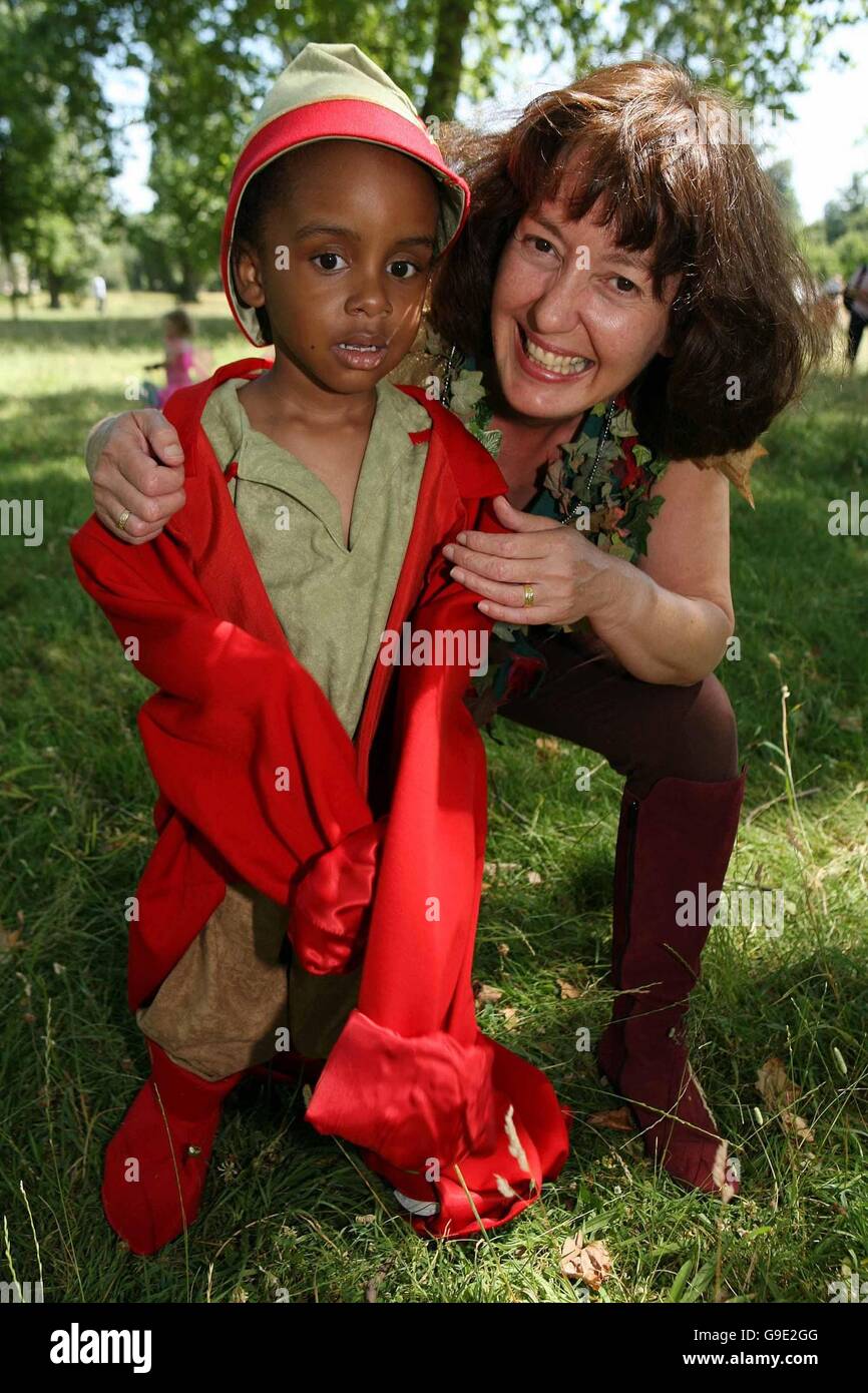 Children's writer Geraldine McCaughrean, right, places a red coat on the shoulders of Great Ormond Street Hospital patient Simeon Lynch-Prime, age 5, left, Saturday, 15 July 2006 during Peter Pan in Kensignton Gardens, an event to benefit Great Ormond Street Hospital. McCaughrean is the author of, 'Peter Pan in Scarlet,' the official sequel to Peter Pan, which will be available on 5 October 2006. Ph: Rebecca Reid Stock Photo