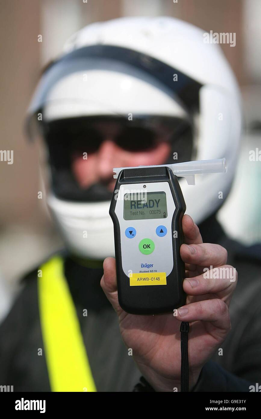 A traffic corp Garda holds up a breathalyser at a news conference in