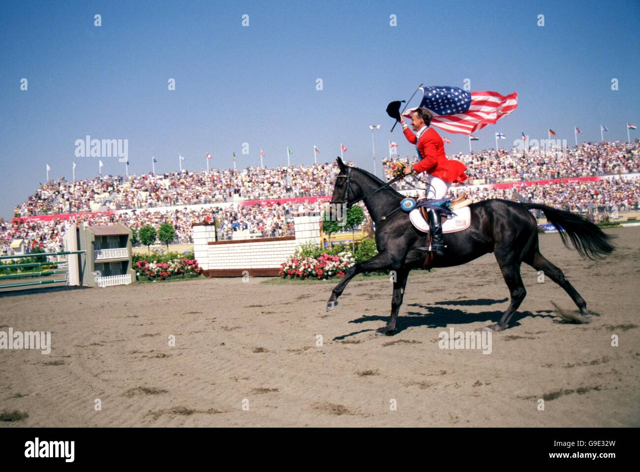 The USA's David O'Connor celebrates his Gold medal victory with the Stars and Stripes Stock Photo
