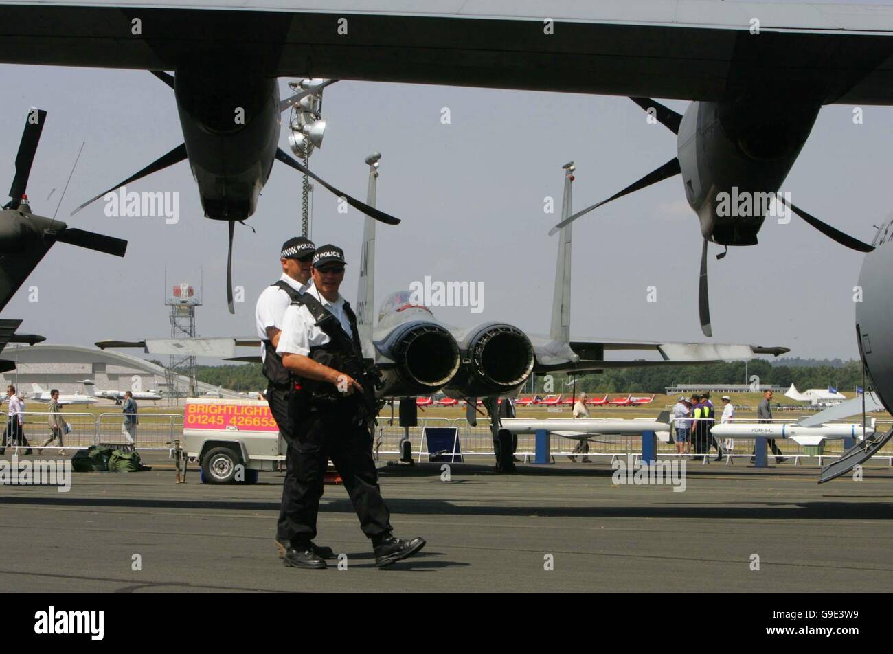 Armed police guard the static aircraft display at the Farnborough International Airshow in Hampshire. Stock Photo