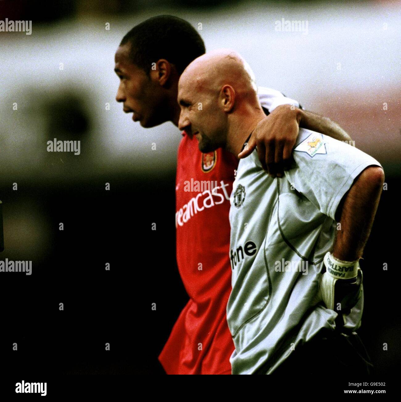 Soccer - FA Carling Premiership - Arsenal v Manchester United. Arsenal's Thierry Henry (l) walks off the field with fellow French international Fabien Barthez (r), the Manchester United goalkeeper Stock Photo