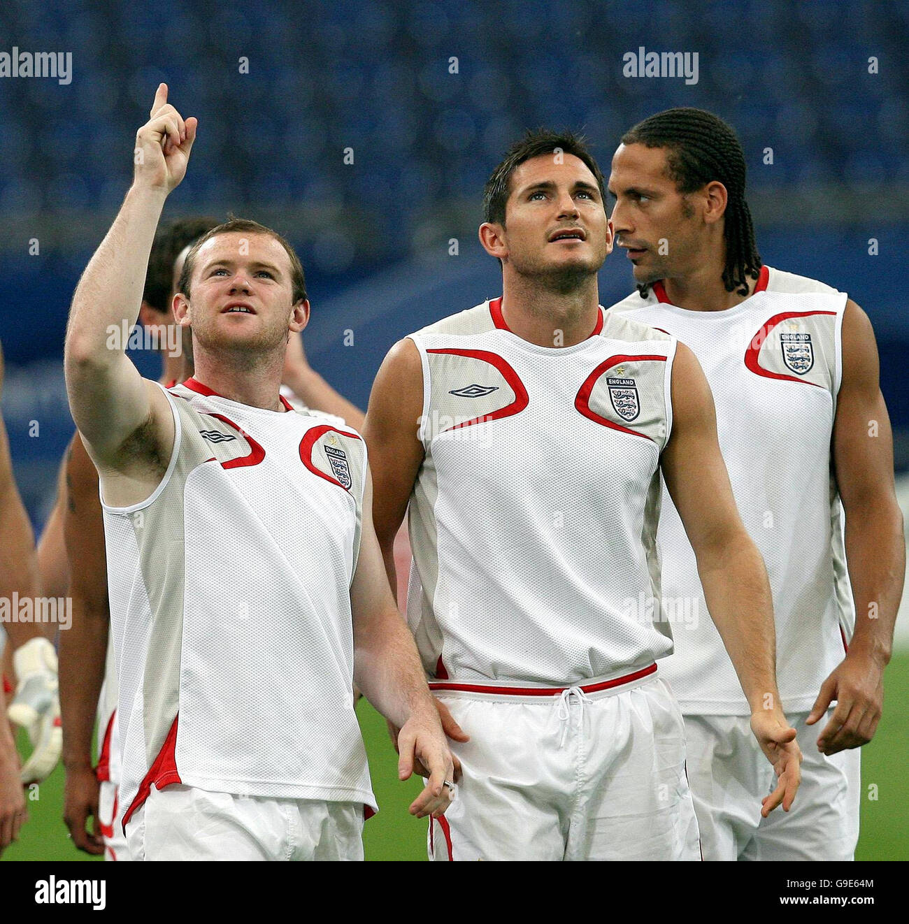 England's Wayne Rooney (left), Frank Lampard and Rio Ferdinand (right) during a training session at the FIFA World Cup Stadium in Gelsenkirchen, Germany. Picture date: Friday June 30, 2006. England play Portugal in their Quarter Final match tomorrow. Photo credit should read: Martin Rickett/PA. 'This image may only be used in (i) wire services, newspapers, magazines, newspaper or magazine supplements and (ii) any internet version of such newspapers, magazines or supplements, or other editorial internet sites provided that these are not intended for, or promoted as being available for, mobile Stock Photo