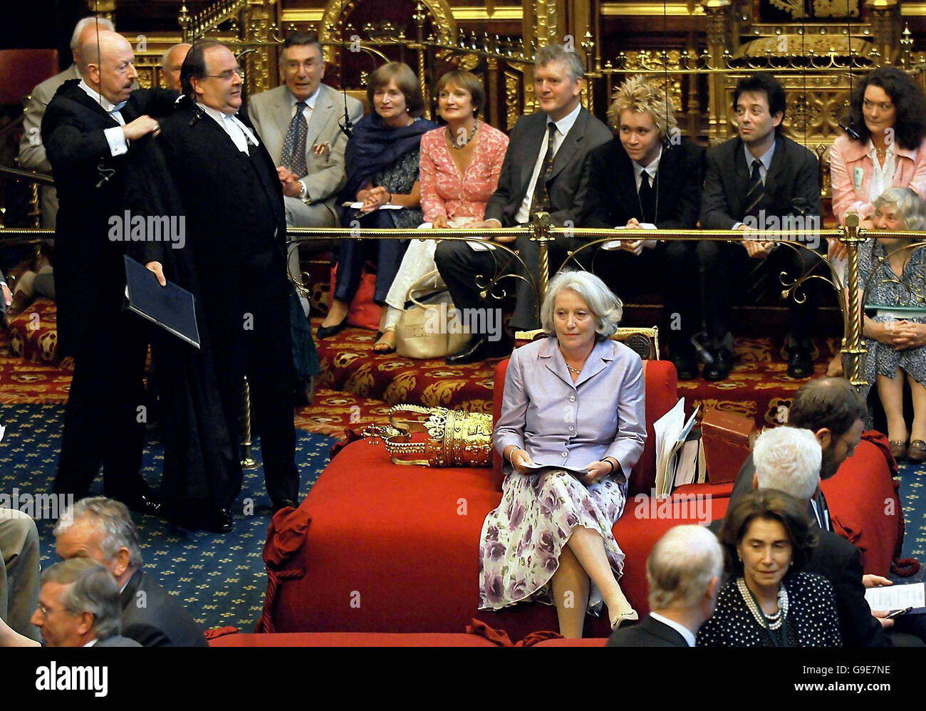 Labour former minister Baroness Hayman sits on the Woolsack in the House of Lords as Lord Falconer (left, holding folder) disrobes, after it was announced that she has been elected the first Lord Speaker of the House of Lords. Stock Photo