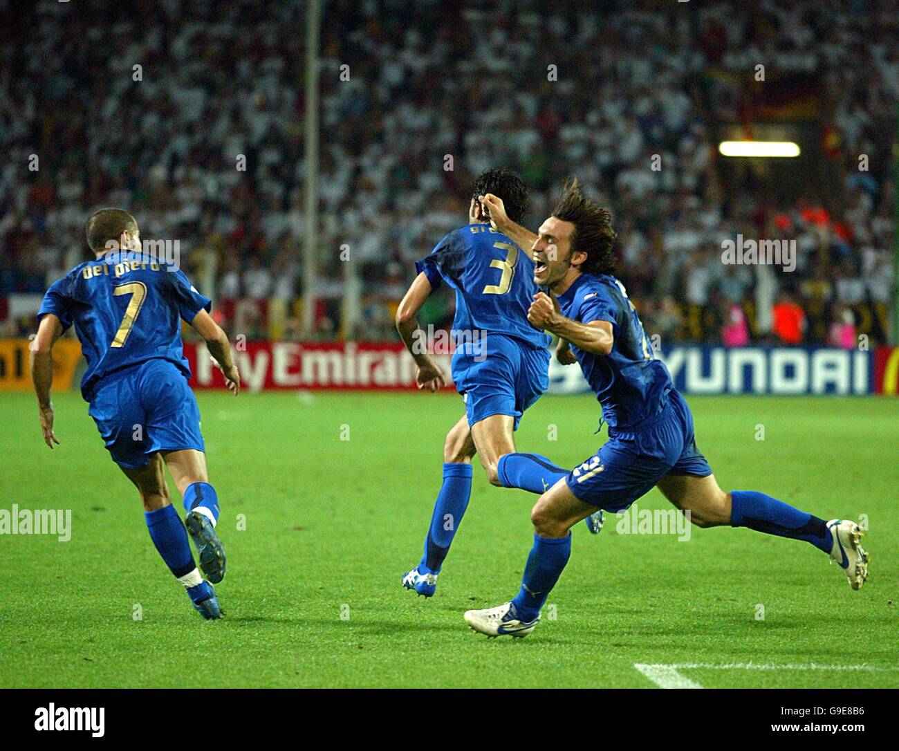 Soccer - 2006 FIFA World Cup Germany - Semi Final - Germany v Italy - Signal Iduna Park. Italy's Fabio Grosso celebrates scoring the opening goal of the game with Andrea Pirlo and Alessandro Del Piero Stock Photo