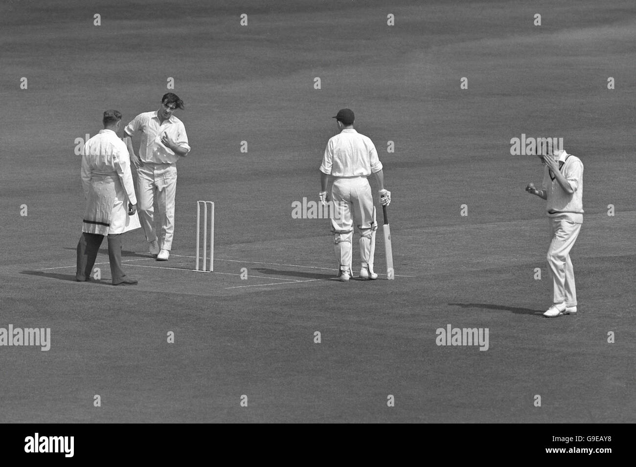 Yorkshire's Fred Trueman (second l) has a word with umpire Harry Sharp (l) after being called for no-balling for the second time in the first session Stock Photo