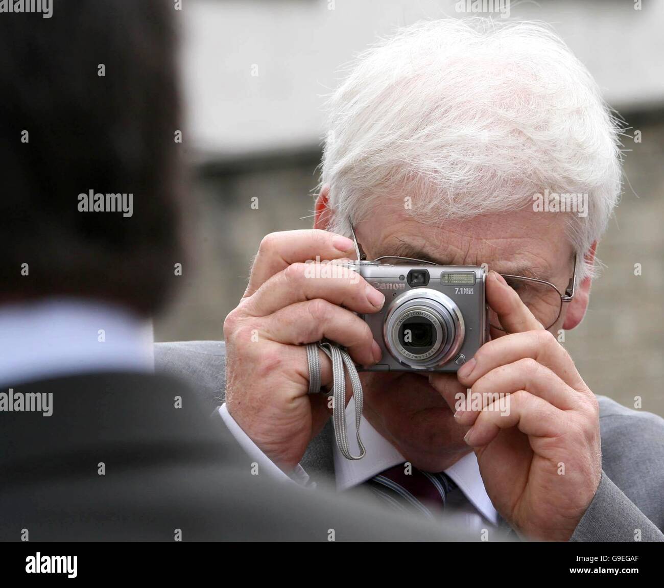 Michael Gallagher, who's son Aidan was killed in the Omagh bomb, takes a photograph of Detective Sergeant John White as he leaves Letterkenny District Court, after he was cleared of planting a shotgun at a traveller encampment in Donegal in a bid to frame a group of men for murder. Stock Photo