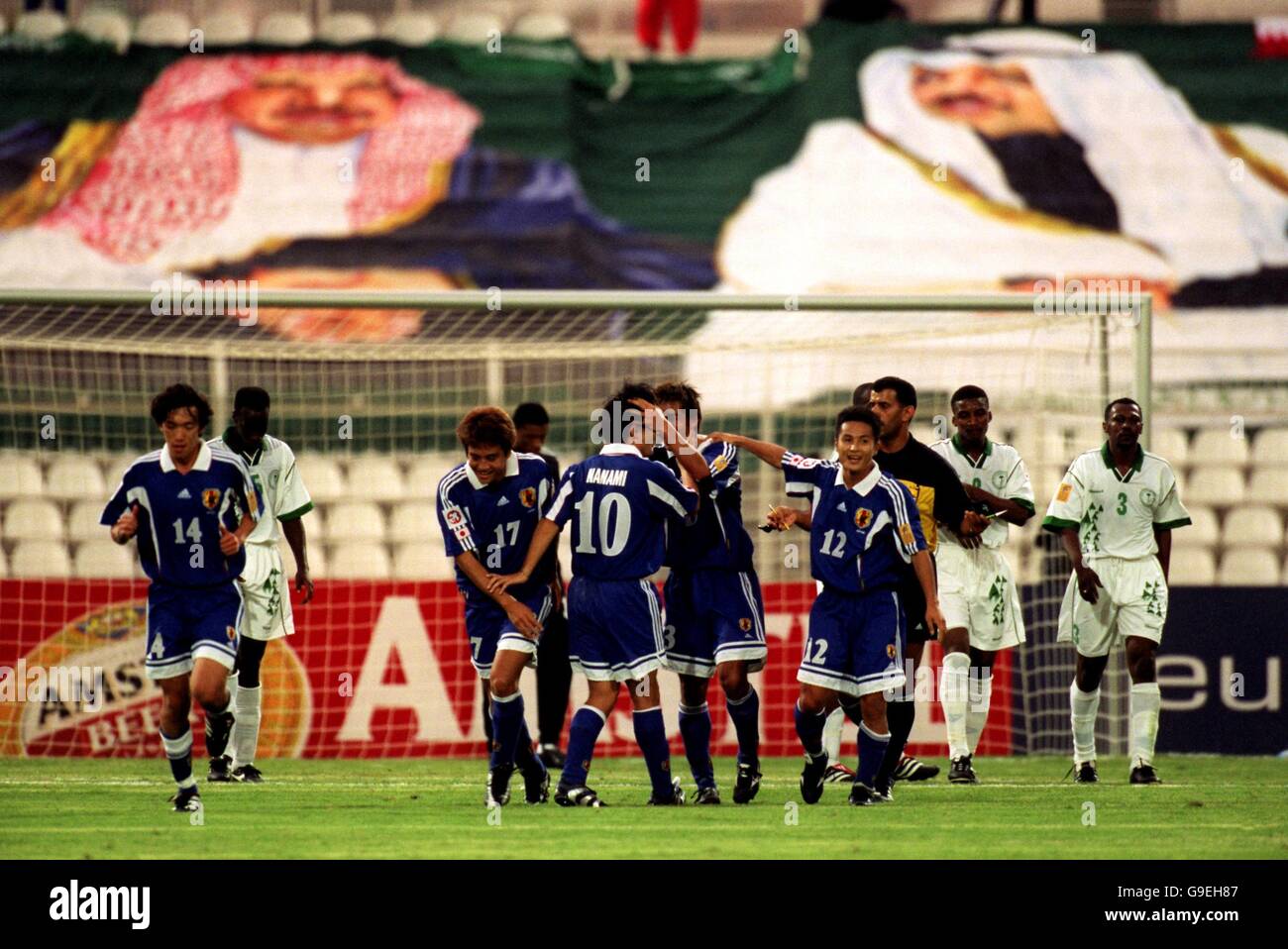 Japan celebrate the second goal in their 4-1 victory over Saudi Arabia with a Saudi Flag with Prince Sultan bin Fahad and Prince Fisul bin Fahad behind the goal Stock Photo