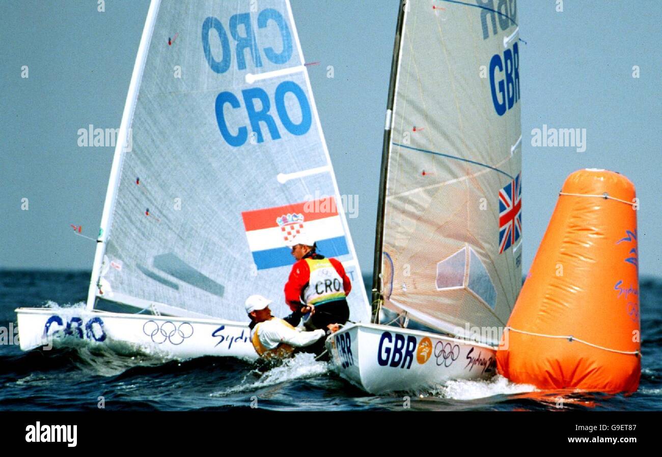Sydney 2000 Olympics - Sailing - Men's Finn Fleet Races 7. Great Britain's Iain Percy beats Croatia's Karlo Kuret to the outer marker buoy Stock Photo