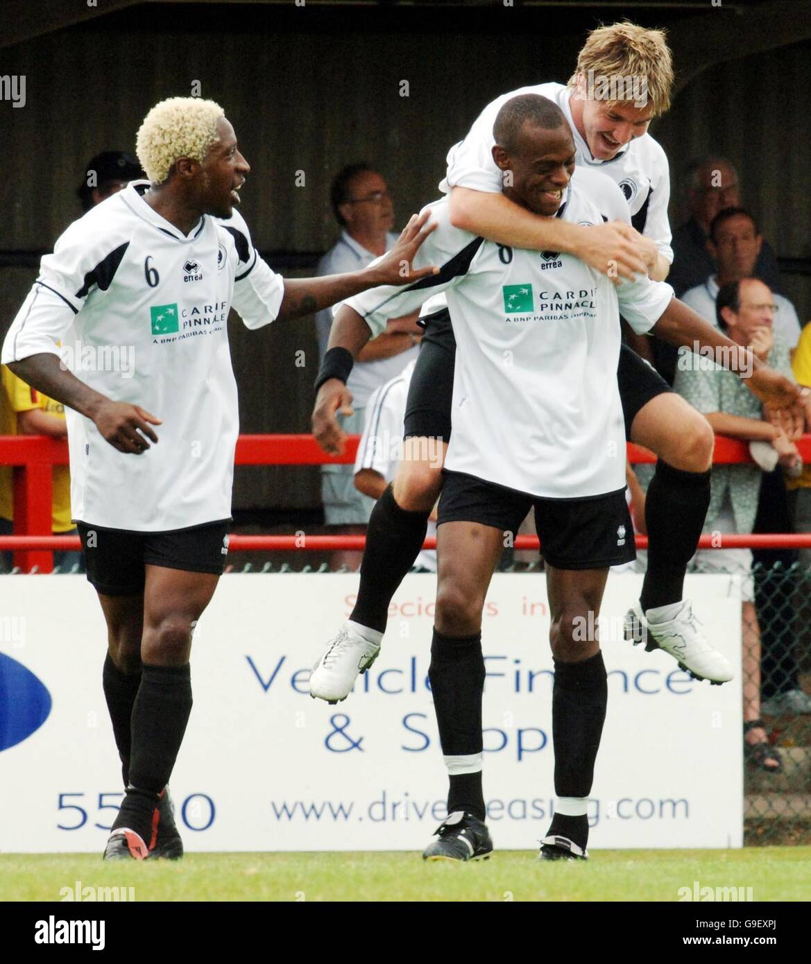 Boreham wood's Darrell Cox celebrates his goal against Watford with on his back Michael Cox and Marvin Samuel (left) during a pre-season friendly at Meadow Park, London. Stock Photo