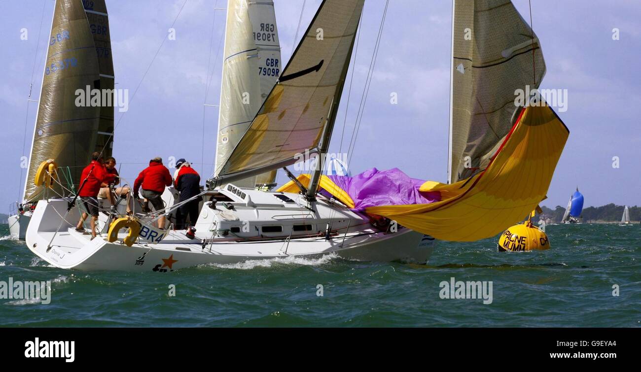A crewman on Doris J takes a tumble on the foredeck as he pulls the  spinnaker down on the Solent on the second day of the Skandia Cowes Week  regatta off Cowes,