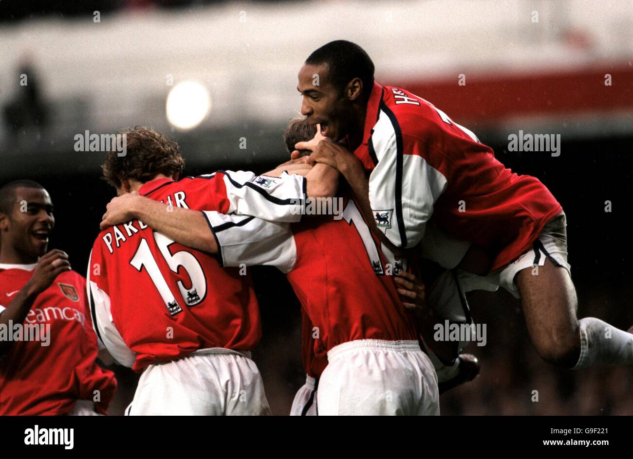 Arsenal's Ray Parlour (l) and Thierry Henry (r) congratulate Dennis Bergkamp (c) on scoring Stock Photo