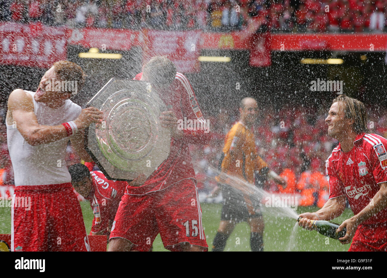Liverpool's Bolo Zenden sprays winning goalscorers John Arne Risse and Peter Crouch with champagne Stock Photo