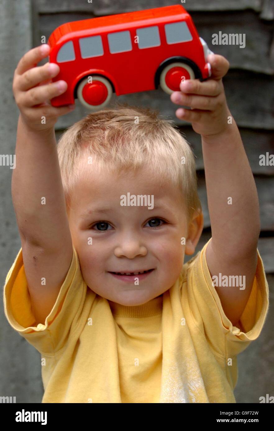 Leon Smith, 3, from Braintree, Essex holds up a toy bus after being reunited with his mum at their home in Braintree. PRESS ASSOCIATION Photo Picture date: Friday August 11 2006. The toddler went missing yesterday after taking a solo bus trip from Braintree to Colchester.See PA Story POLICE Bus. Photo credit should read Chris Radburn/PA Stock Photo