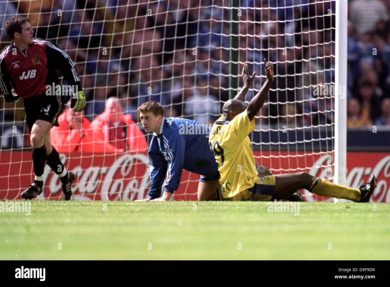 Gillingham's Iffy Onuora (r) claims the ball had crossed the line as Wigan Athletic's Pat McGibbon (c) and goalkeeper Derek Stillie (l) await the referee's decision Stock Photo