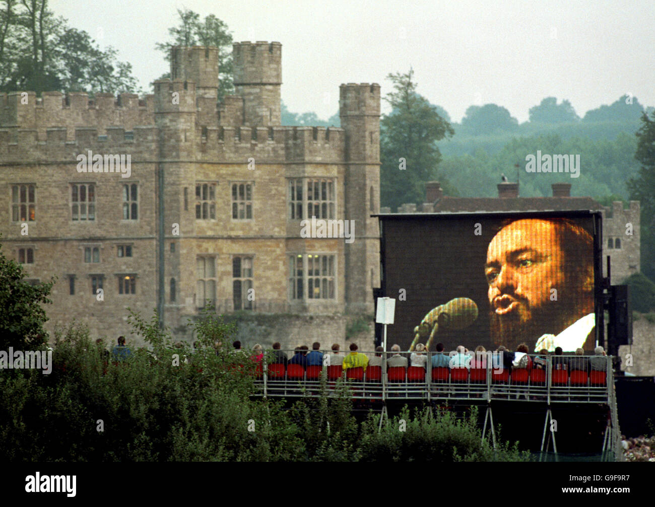 Opera star Luciano Pavarotti appears on a giant screen during his open air concert at Leeds Castle. Stock Photo