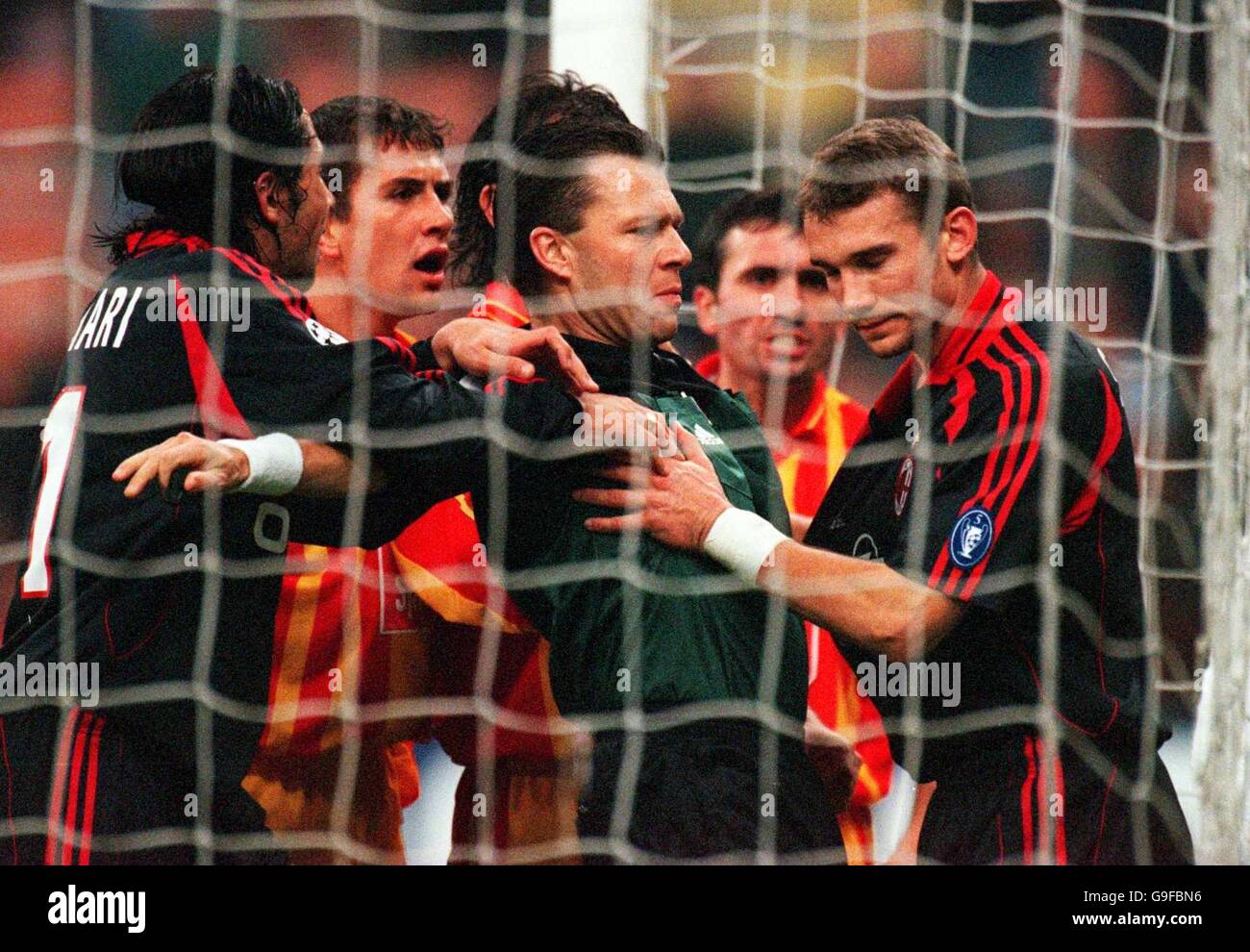 Referee, Urs Meier protects AC Milan's Andriy Shevchenko from the wrath of  the Galatasaray players after awarding a disputed penalty Stock Photo -  Alamy