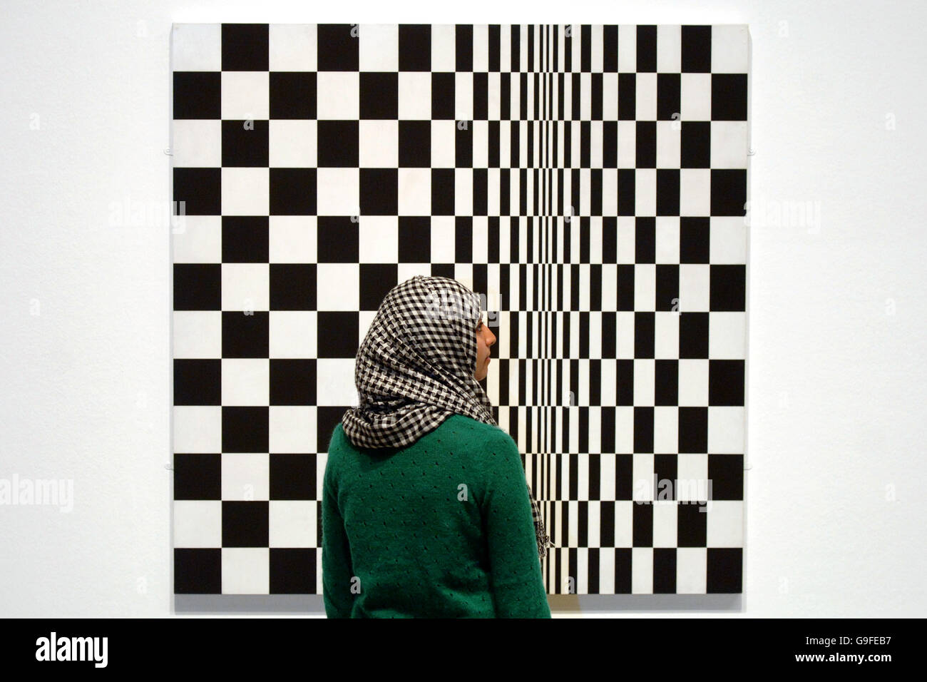 A woman looking at Bridget Riley's Movement in Squares, 1961, at the press day of an exhibition called How to Improve the World: 60 Years of British Art, at the Hayward Gallery in the South Bank Centre, central London. Stock Photo
