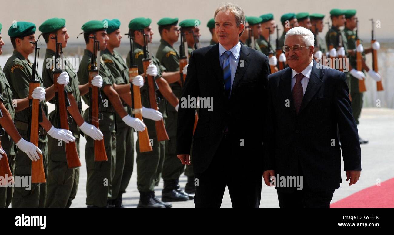 British Prime Minister Tony Blair (left) with Palestinian President Mahmoud Abbas as they walk past a Guard of Honour of Palestinian Security forces at the Presidential Compound in Ramallah, West Bank . Stock Photo