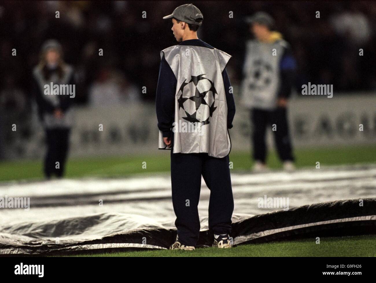 A UEFA Champions League ball boy stands on the edge of the giant ball