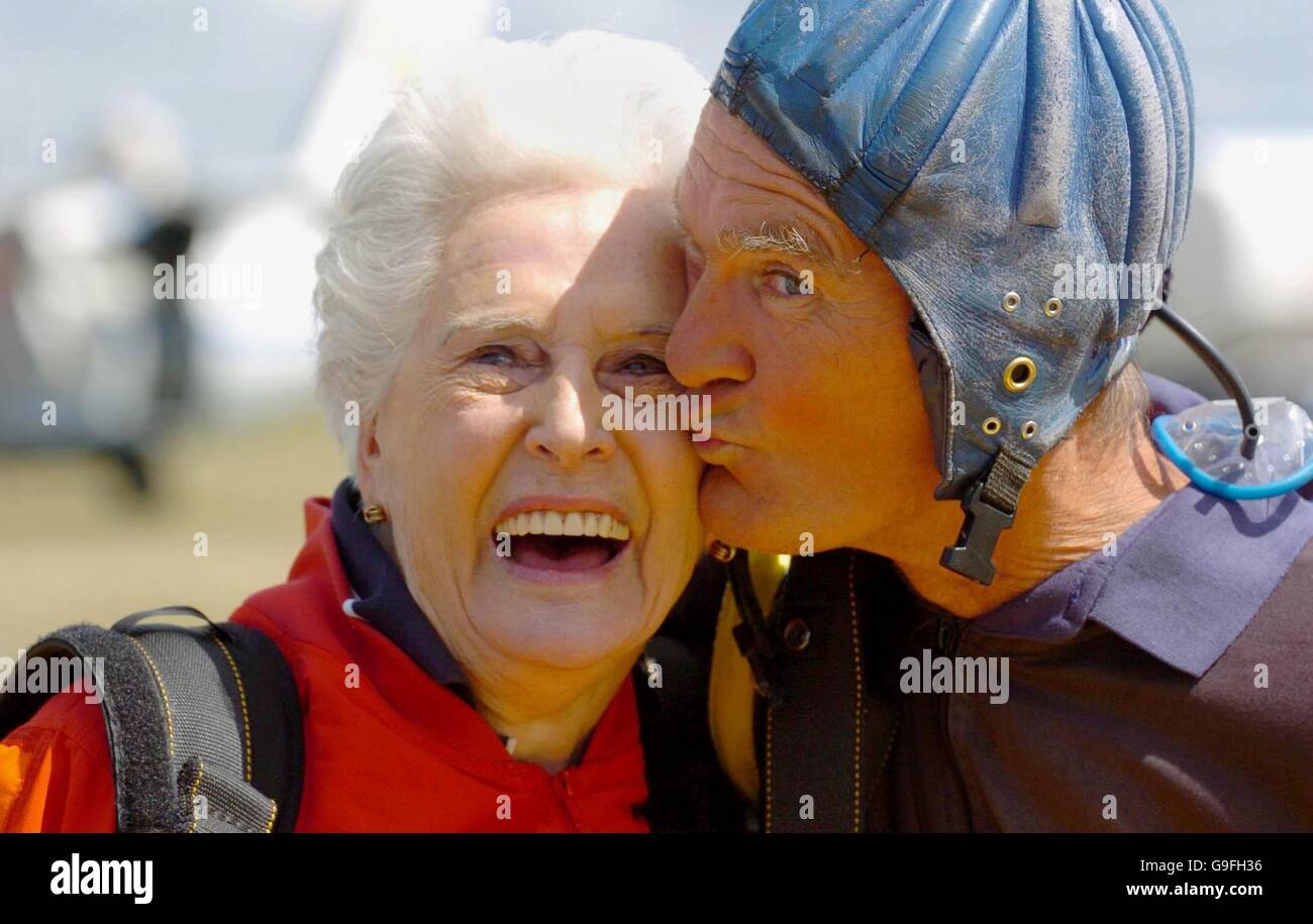 Mary Armstrong, 90, gets a kiss from her tandem instuctor Clem Quinn, after making the 12,000 ft jump at HeadCorn Airfield in Kent. PRESS ASSOCIATION Photo Picture date Tuesday August 8 2006. Mary Armstrong, 90, from East Molesey, near Woking, Surrey, was due to parachute jump at Headcorn airfield in Kent yesterday but was delayed by the weather. The great grandmother-of-nine, who took her first jump at the age of 87, did so today for the Brooke charity which cares for working animals in the worlds poorest countries. Photo credit should read: Chris Radburn/PA Stock Photo