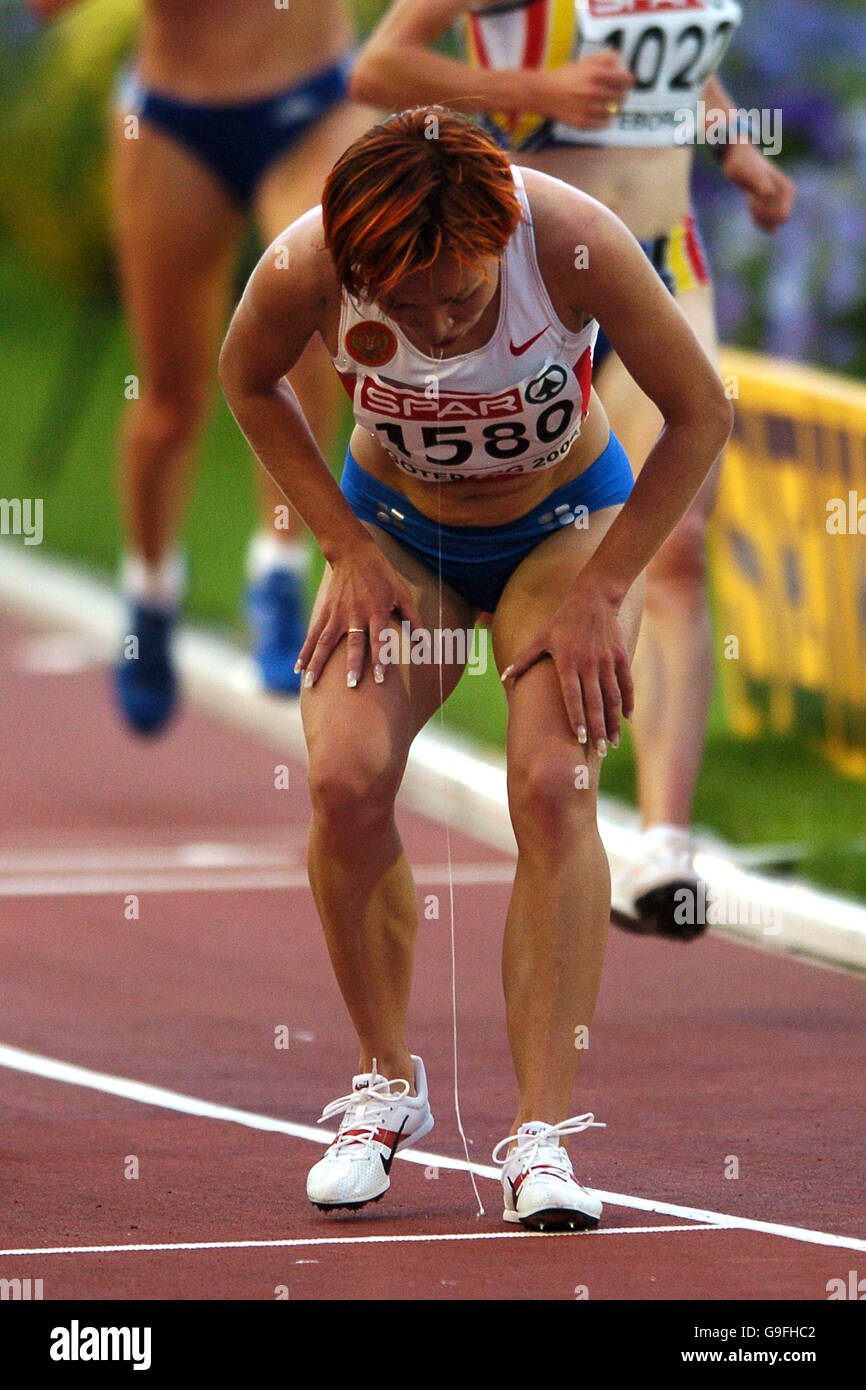 Russia's Inga Abitova vomits after competing in the 10000m Stock Photo