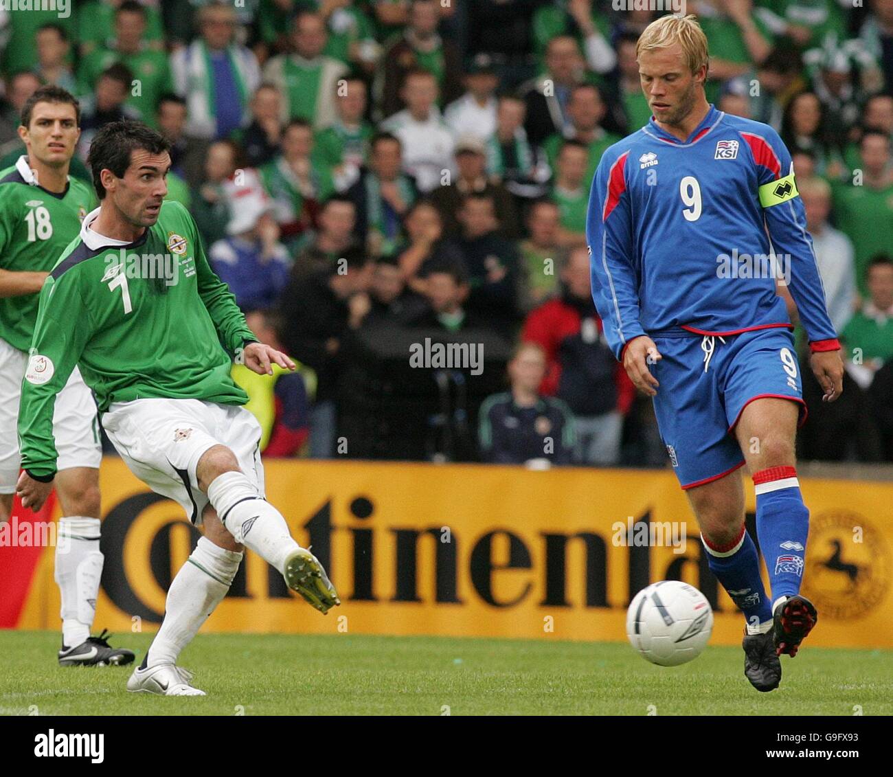 Northern Ireland's Keith Gillespie (left) in action with Iceland's Eidur Gudjohnsen during the European Championship qualifying match at Windsor Park, Belfast. Stock Photo