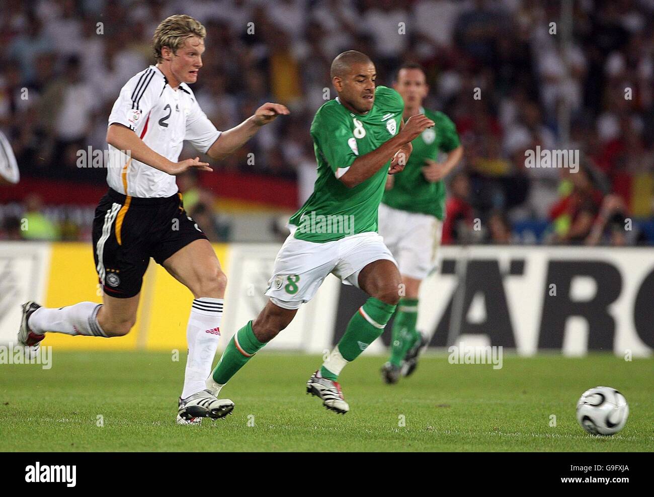 Republic of Ireland's Steven Reid in action against Germany's Marcell Jansen (L) during the European Championship qualifying match at the Gottlieb-Daimler Stadium, Stuttgart, Germany. Stock Photo