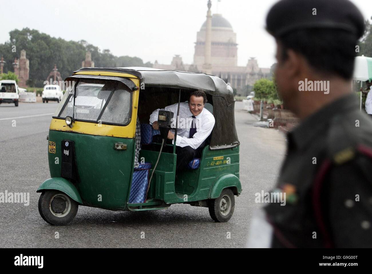 David Cameron, leader of Britain's Conservative Party, rides in a Tuk Tuk on Raysina Hill in the Indian capital Delhi, on the third day of his four-day tour. Stock Photo