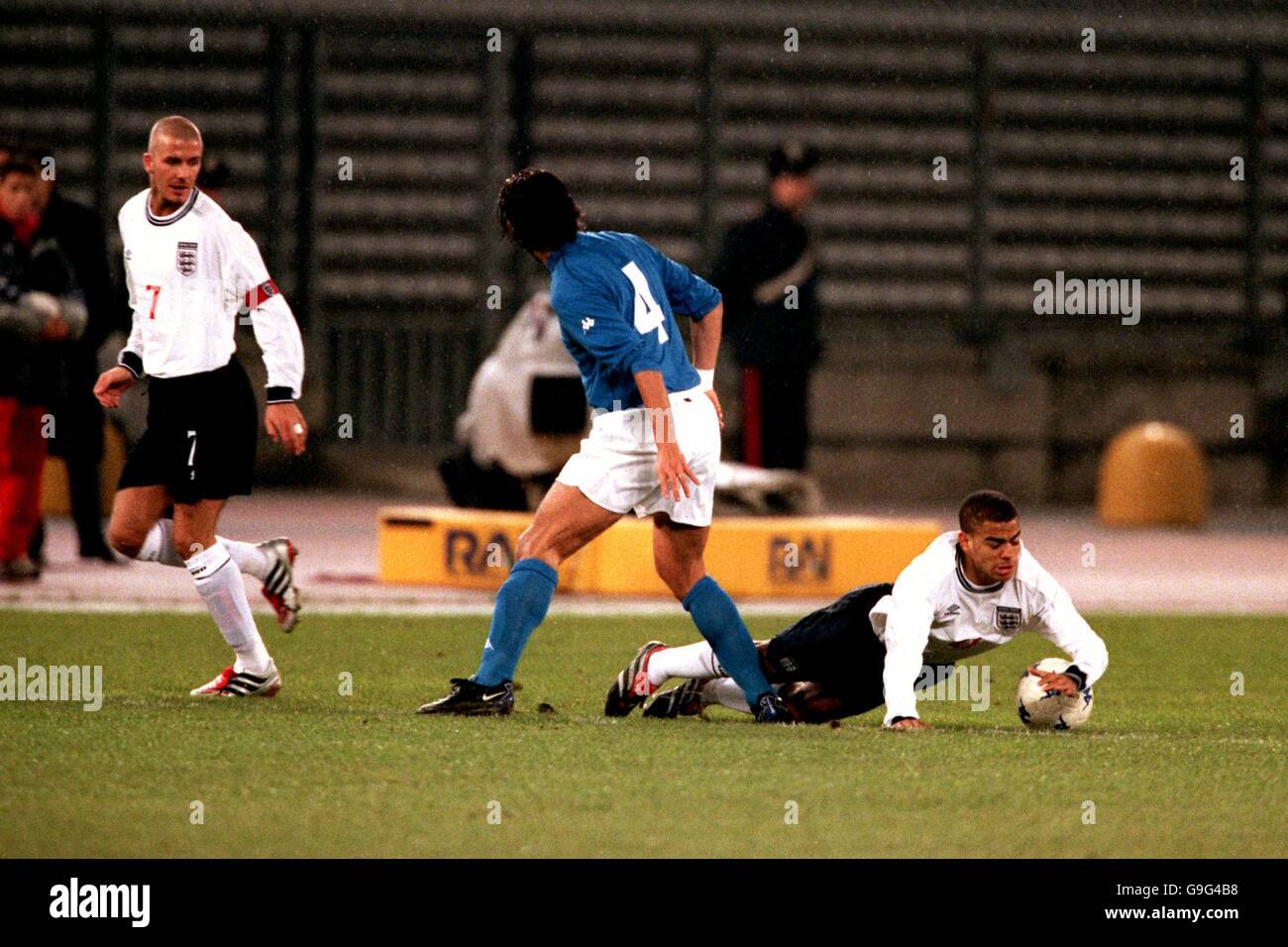 England's Kieron Dyer (r) goes down under pressure from Italy's Demetrio Albertini (c) as David Beckham (l) looks on Stock Photo